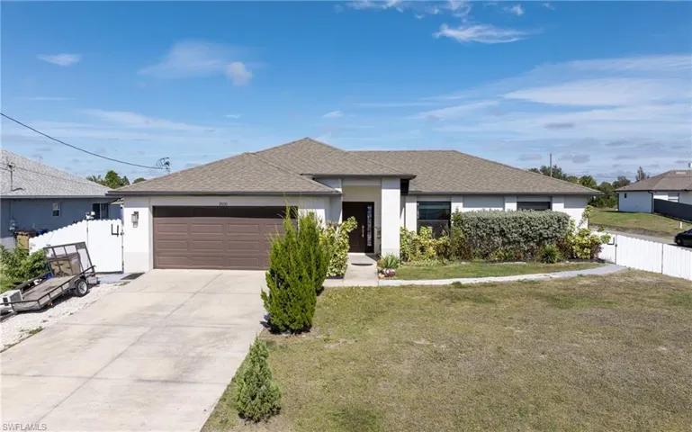 View of front of house featuring roof with shingles, driveway, stucco siding, and a garage