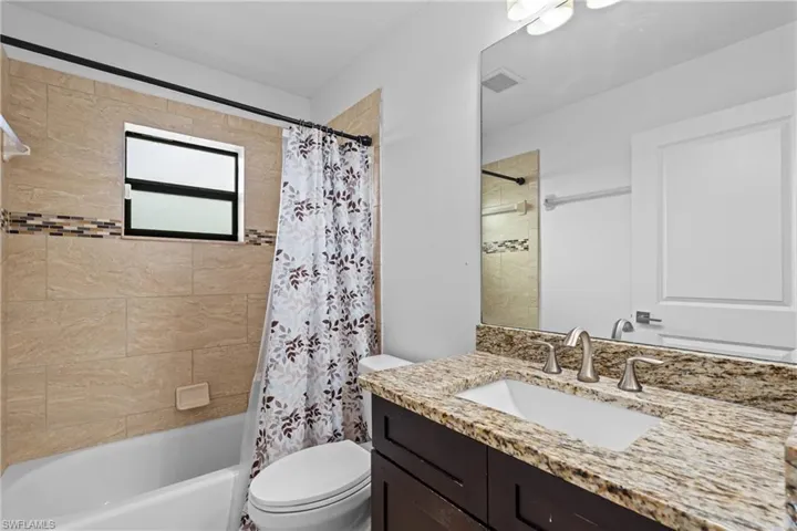 Full bathroom with vanity and shower / bathtub combination with curtain