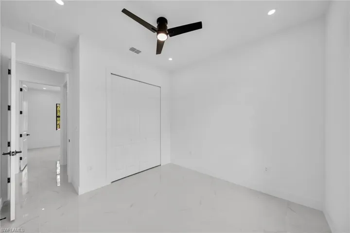 Unfurnished bedroom with light marble finish flooring, recessed lighting, a closet, and ceiling fan