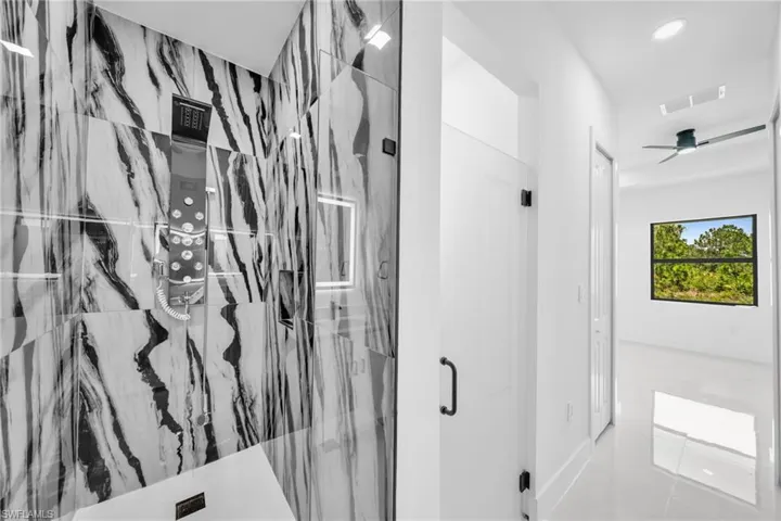 Full bathroom featuring a marble finish shower, recessed lighting, and ceiling fan
