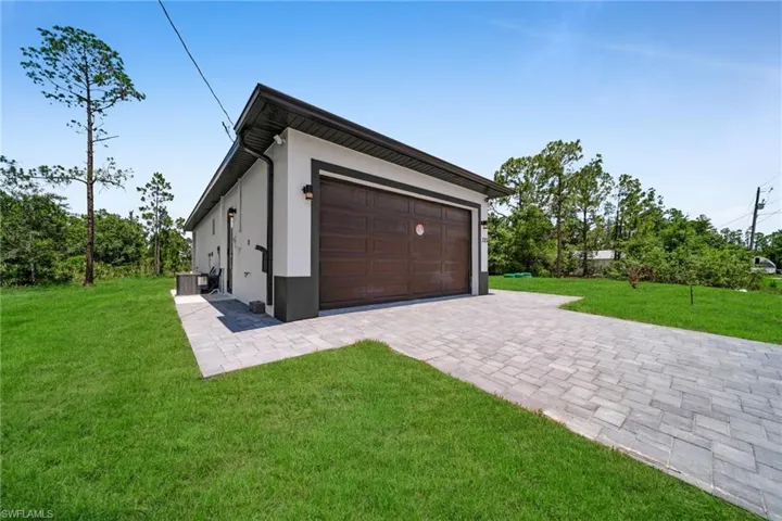 Garage featuring decorative driveway