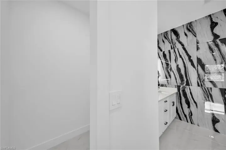 Bathroom with marble finish flooring and vanity