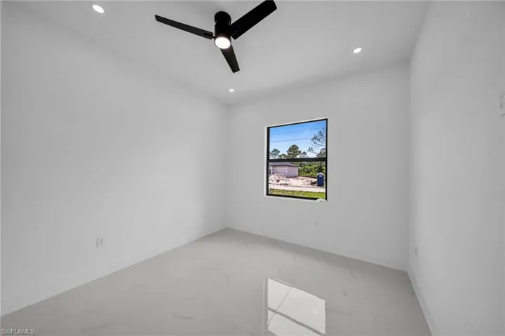 Unfurnished room featuring light marble finish floors, recessed lighting, and ceiling fan