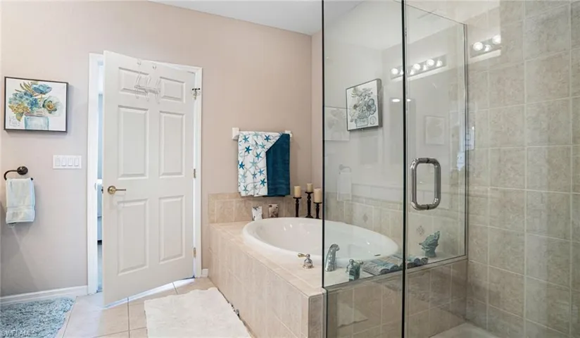 Master Bathroom featuring separate shower and tub and tiled floors