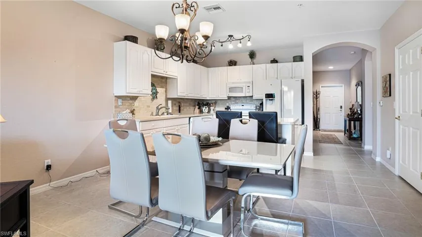 Dining space with tiled floors, a chandelier