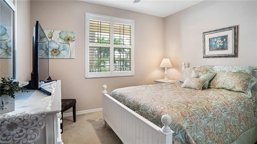 Carpeted guest bedroom with ceiling fan