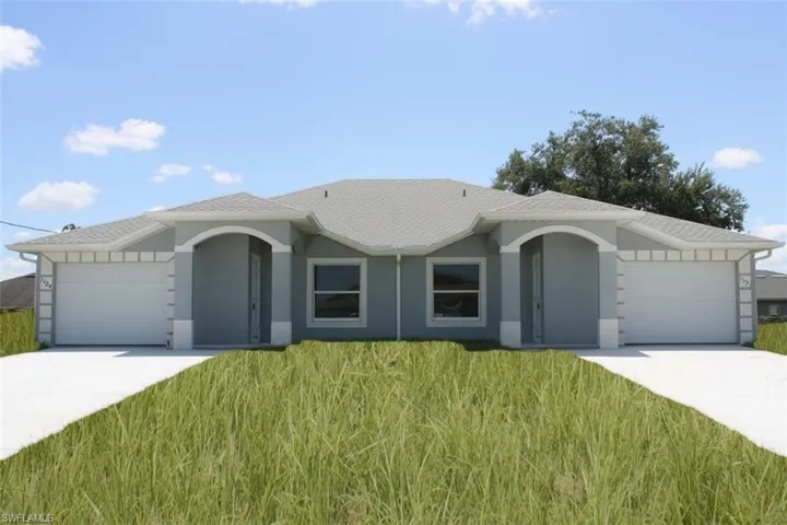 Duplex property featuring a light gray exterior, white trim, and a gray shingle roof