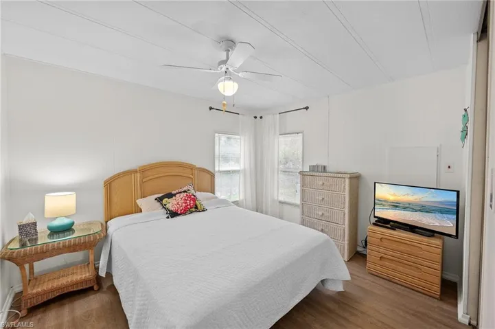 Bedroom featuring wood finished floors and ceiling fan