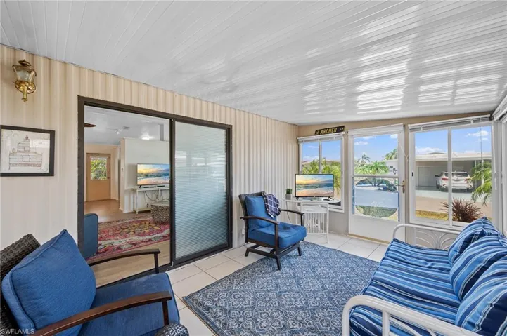 Sunroom featuring outdoor lounge area and tile patterned floors