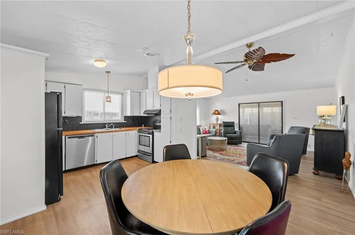Dining room featuring light wood-style floors, a ceiling fan, and visible vents