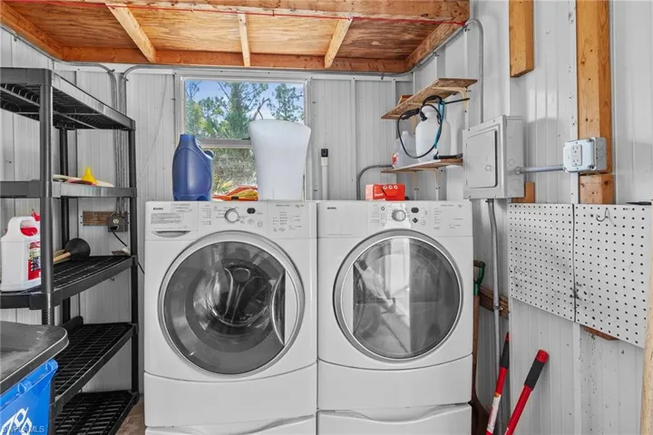 Clothes washing area with wooden ceiling