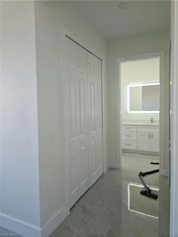 Hall with baseboards and light marble finish flooring