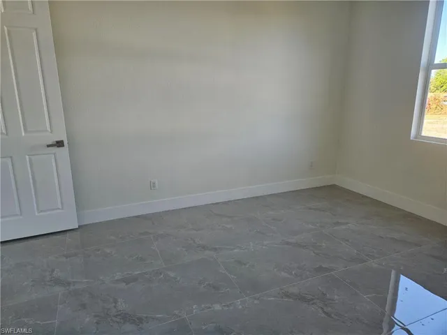 Empty room featuring baseboards