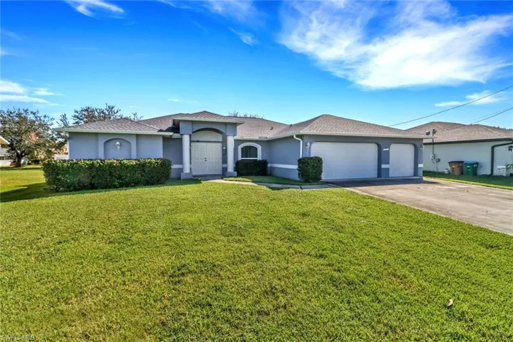 Single story home featuring a front yard and a garage