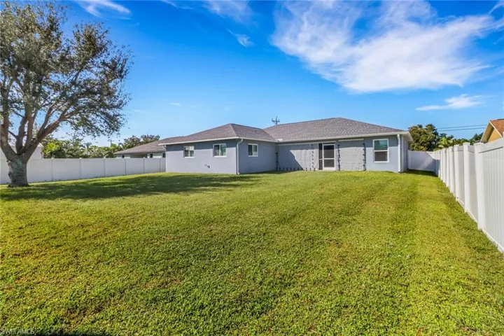 Rear view of property featuring a yard