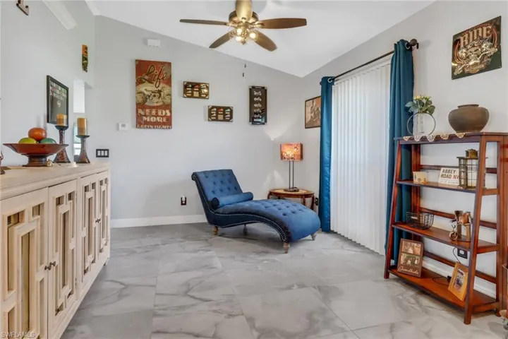 Sitting room with ceiling fan and lofted ceiling