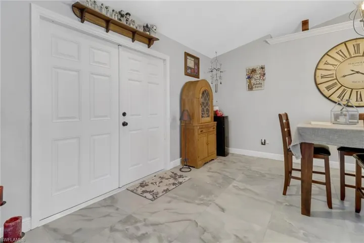 Entryway featuring lofted ceiling