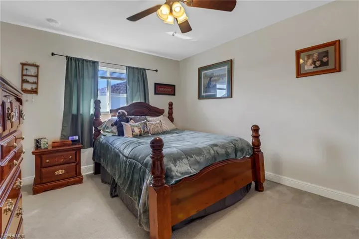 Carpeted bedroom with ceiling fan