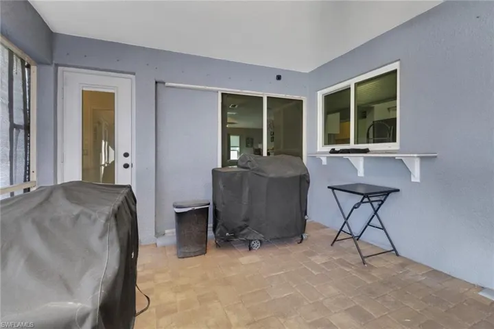 View of patio featuring a grill