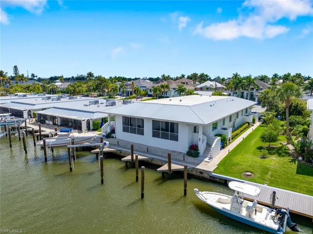 Canal view of home and dock area