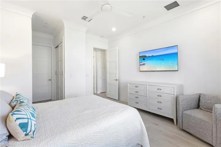 Master Bedroom featuring crown molding, light Cerramic Tile flooring, ceiling fan, recessed lighting, and a closet