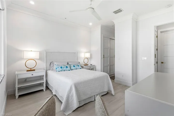 Bedroom with light wood-type flooring, ornamental molding, recessed lighting, a ceiling fan, and a closet