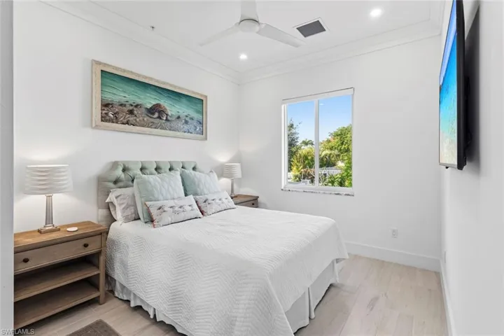Guest Bedroom with ornamental molding, light Ceramic Tile flooring, ceiling fan, and recessed lighting