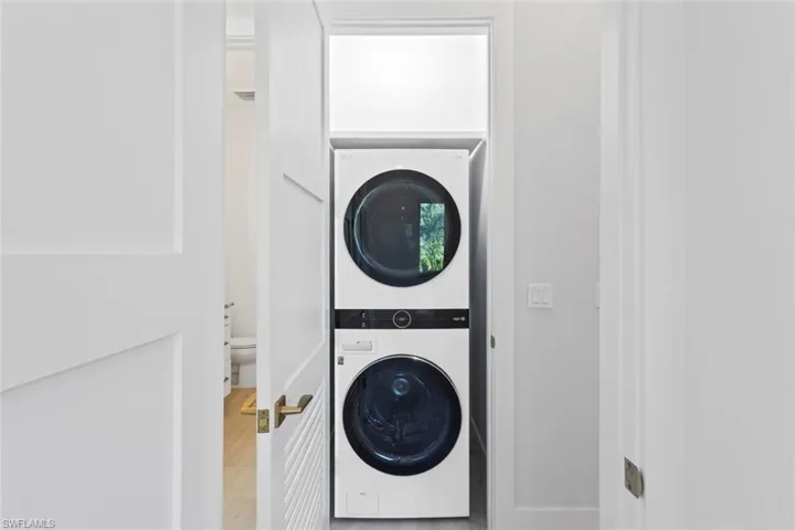 Laundry area featuring stacked washer and dryer