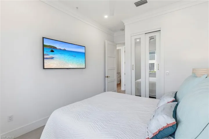 Guest Bedroom with crown molding, Ceramic Tile flooring, a closet, and recessed lighting