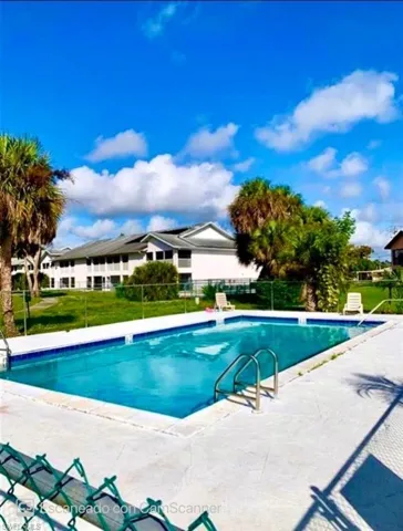 View of swimming pool with a patio area and a lawn