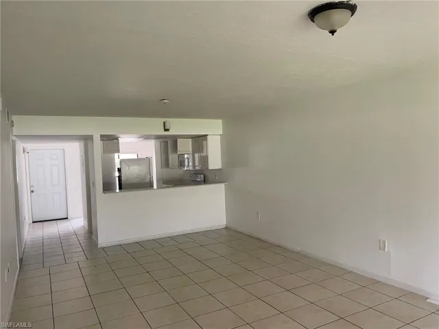 Unfurnished living room featuring light tile patterned floors