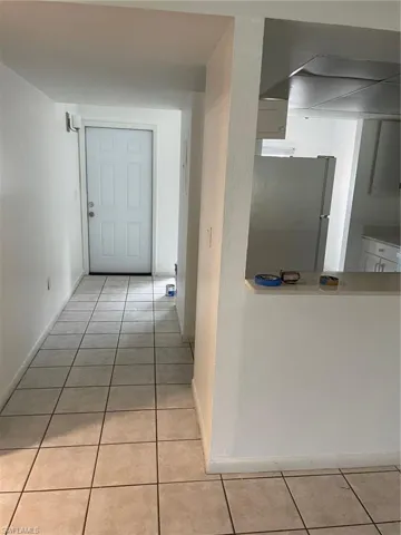 Hall featuring light tile patterned floors