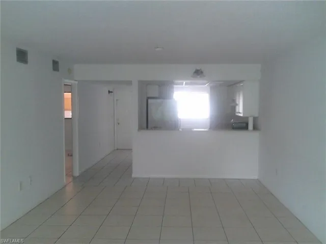 Empty room featuring light tile patterned floors
