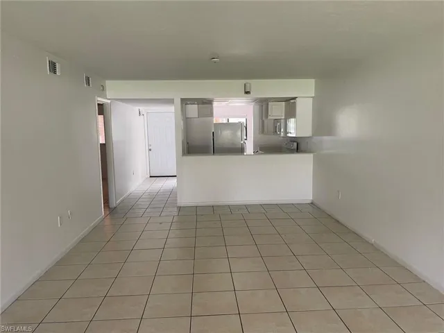 Unfurnished living room featuring light tile patterned floors
