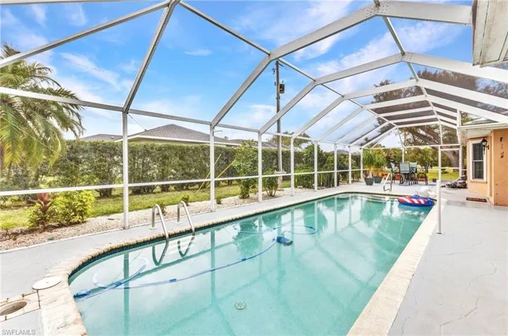 Pool with a lanai and a patio area