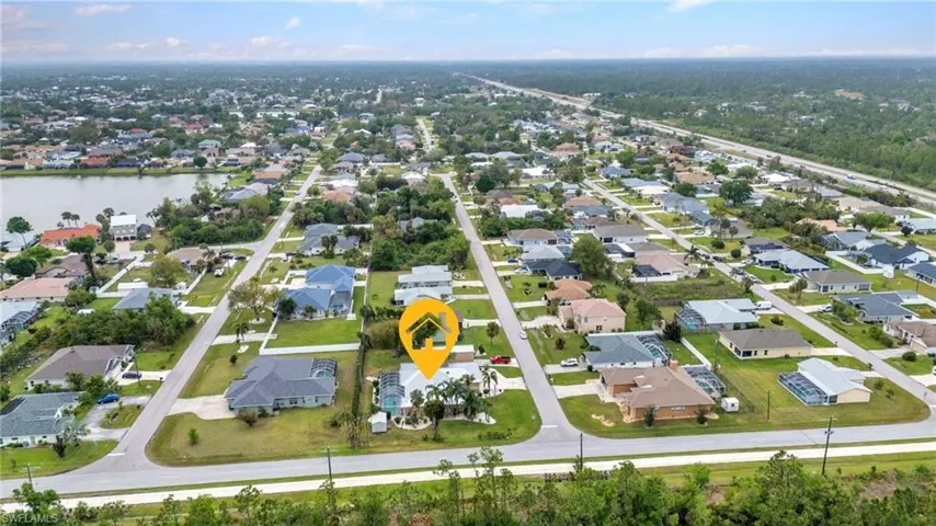 Birds eye view of property with a residential view and a water view