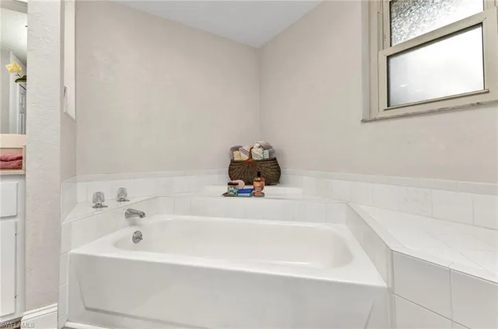 Full bathroom featuring a bath