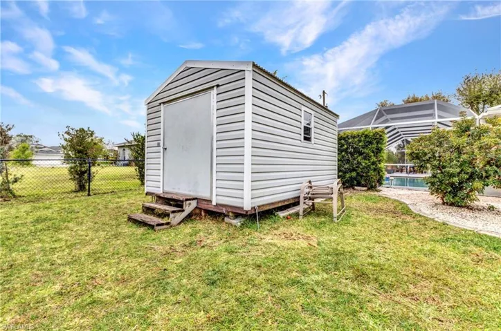 View of shed featuring a fenced in pool and a fenced backyard
