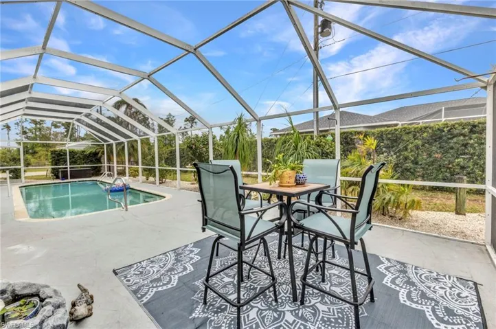 Pool with glass enclosure and a patio