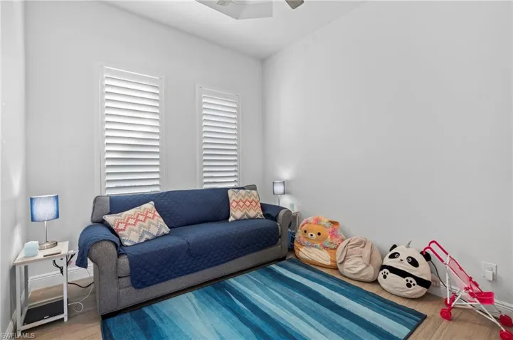 Living room featuring ceiling fan and wood-type flooring