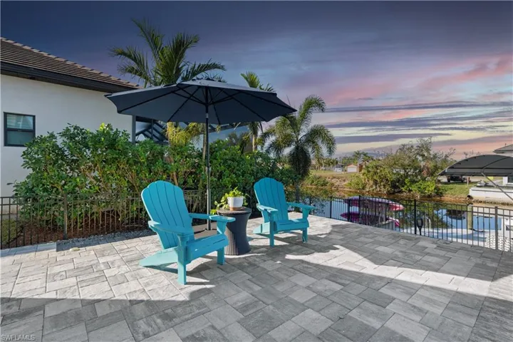 Patio terrace at dusk featuring fence