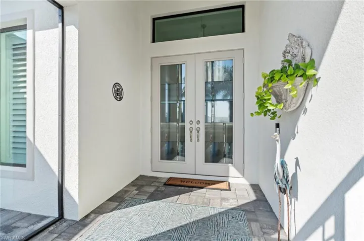 View of exterior entry featuring french doors