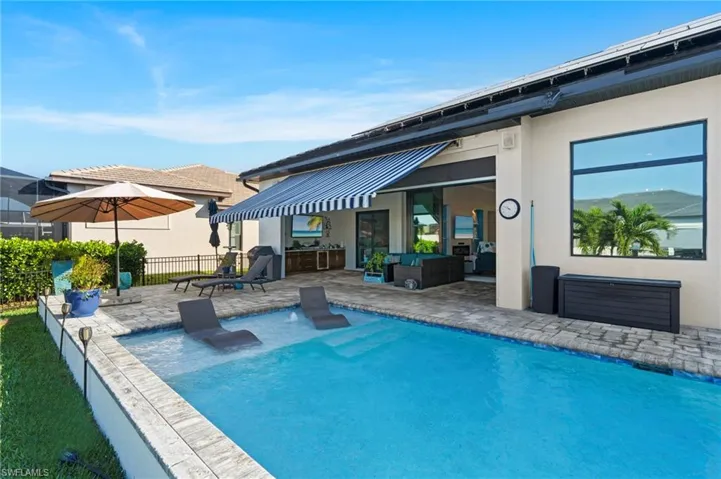 View of pool with an outdoor living space and a patio