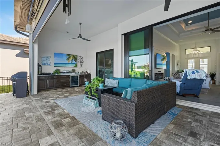 View of patio featuring ceiling fan, outdoor lounge area, wine cooler, and grilling area