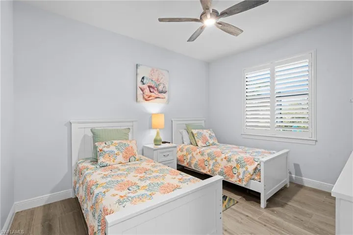 Bedroom with ceiling fan and light wood-type flooring