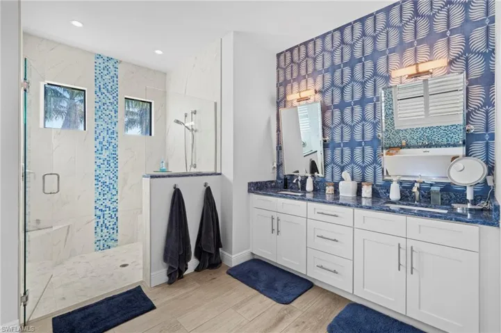 Bathroom with vanity, wood-type flooring, and separate shower and tub