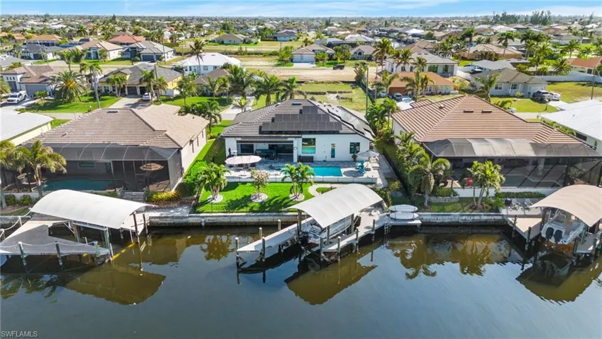 Birds eye view of property with a water view