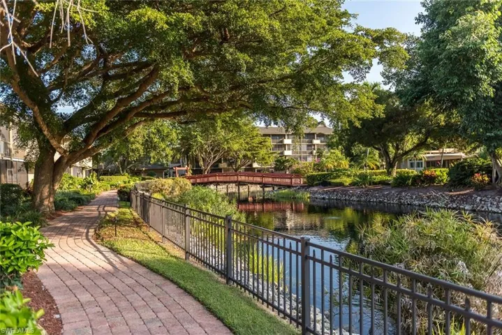View of property's community with a water view and fence