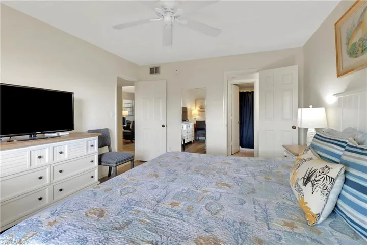 Bedroom with ceiling fan and wood finished floors