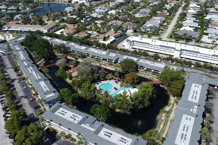 View of property location with a pool area, nearby suburban area, and a nearby body of water